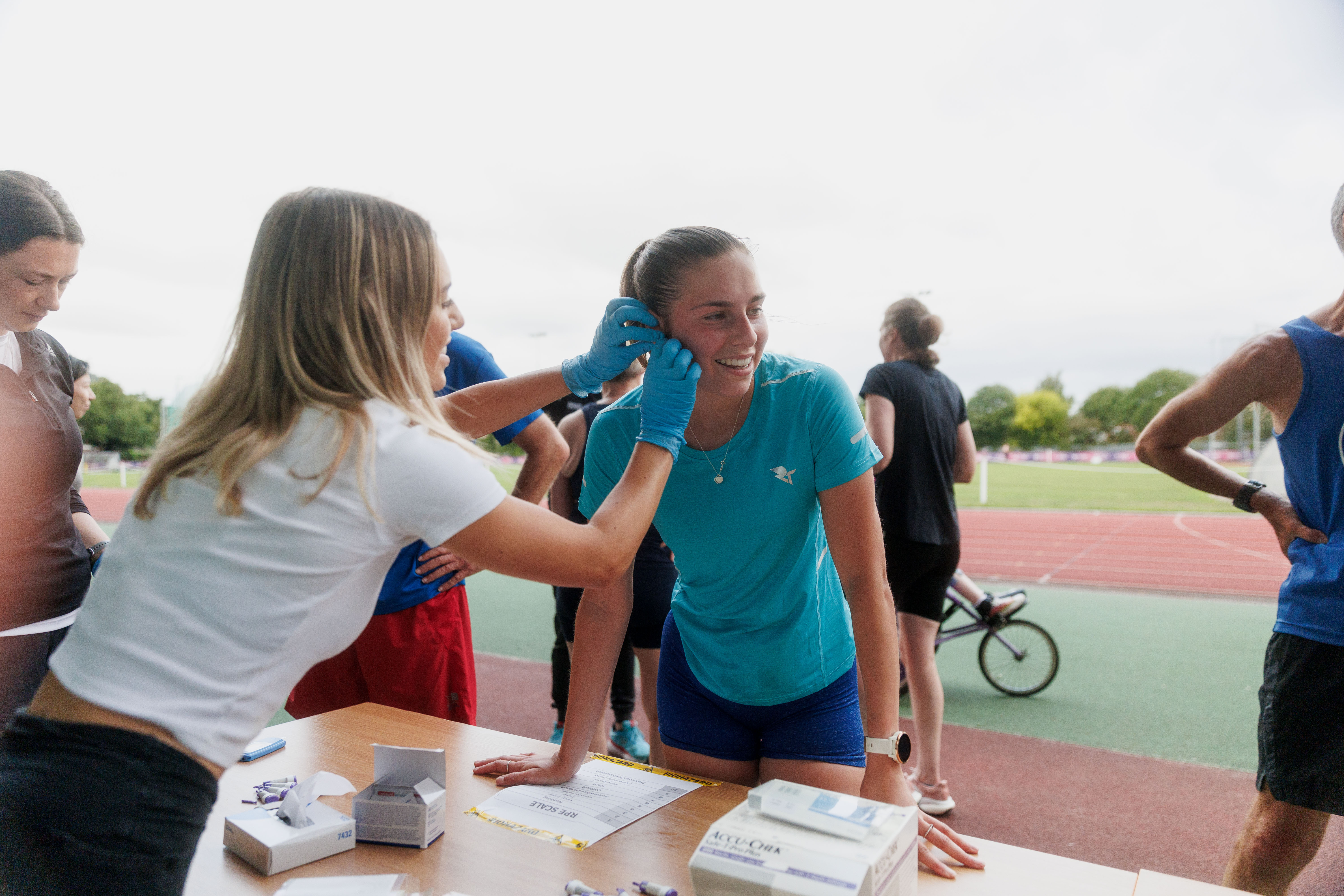 A coach taking a lactate sample at a RunThrough physiology workshop