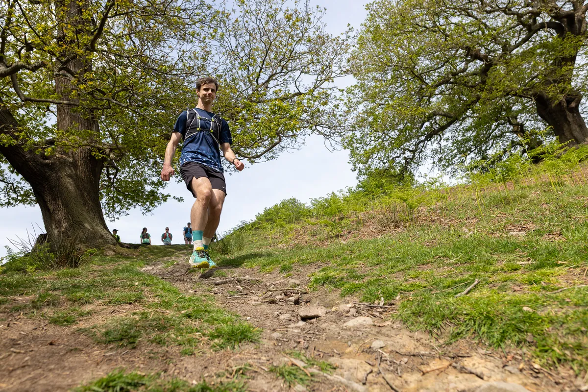 A runner powering up a climb on the trails