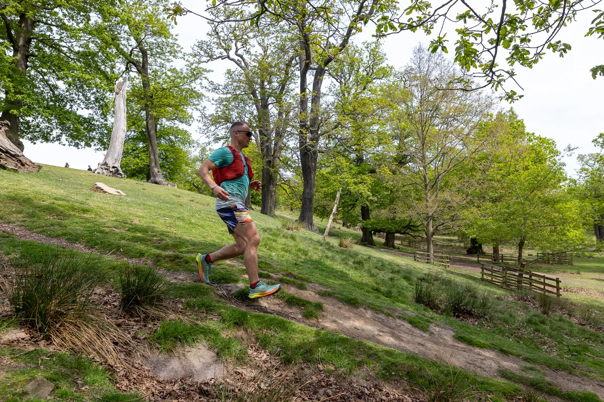 A runner flying down a wooded descent